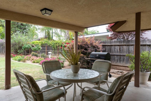 167 W Quincy Ave, Fresno, CA 93711 - view of patio featuring outdoor dining space, a grill, and fence