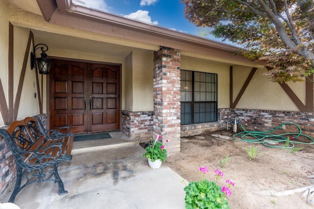167 W Quincy Ave, Fresno, CA 93711 - doorway to property with stucco siding and brick siding