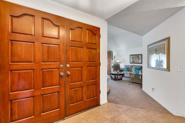 167 W Quincy Ave, Fresno, CA 93711 - entryway featuring baseboards, light carpet, a textured ceiling, and vaulted ceiling