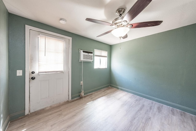3336 N Lafayette Ave, Fresno, CA 93705 - interior space featuring a ceiling fan, a wall mounted AC, wood finished floors, and baseboards