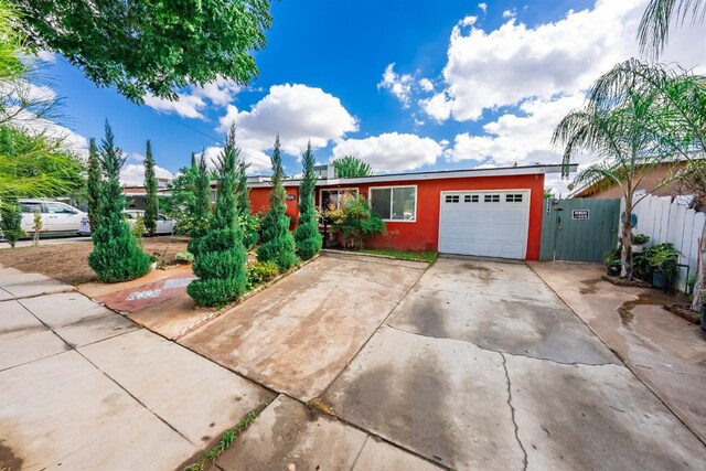 3336 N Lafayette Ave, Fresno, CA 93705 - ranch-style house with concrete driveway, stucco siding, an attached garage, and fence