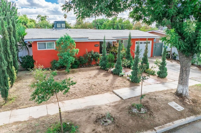 3336 N Lafayette Ave, Fresno, CA 93705 - view of front of home with stucco siding, concrete driveway, and an attached garage