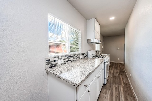 3336 N Lafayette Ave, Fresno, CA 93705 - kitchen with white gas range oven, under cabinet range hood, dark wood-type flooring, baseboards, and white cabinets