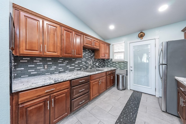 3336 N Lafayette Ave, Fresno, CA 93705 - kitchen featuring a sink, decorative backsplash, light tile patterned floors, vaulted ceiling, and freestanding refrigerator