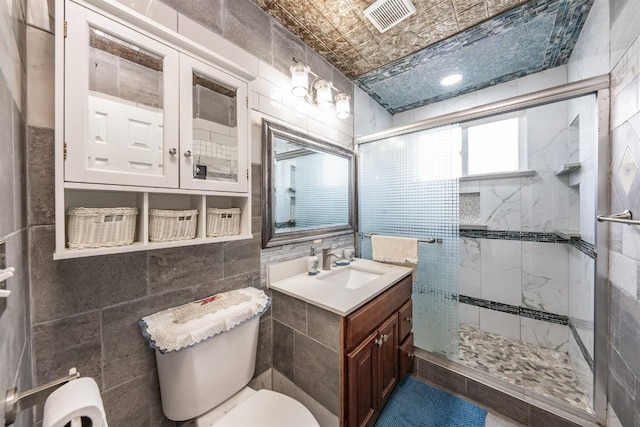 3336 N Lafayette Ave, Fresno, CA 93705 - bathroom featuring tile walls, toilet, vanity, a stall shower, and an ornate ceiling