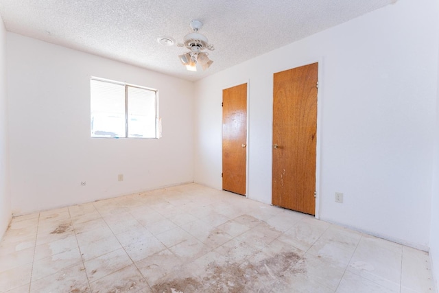 603 E Compton Ave, Pixley, CA 93256 - unfurnished bedroom featuring a textured ceiling