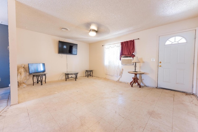603 E Compton Ave, Pixley, CA 93256 - foyer entrance featuring cooling unit, a textured ceiling, visible vents, and tile patterned floors