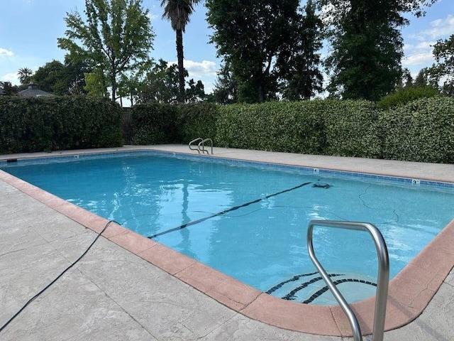 view of swimming pool with a fenced in pool and a fenced backyard