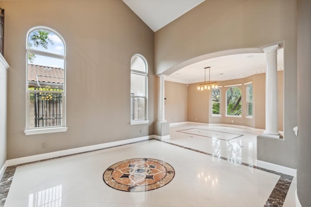 4918 W Bluff Ave, Fresno, CA 93722 - unfurnished room with ornate columns, high vaulted ceiling, arched walkways, and baseboards