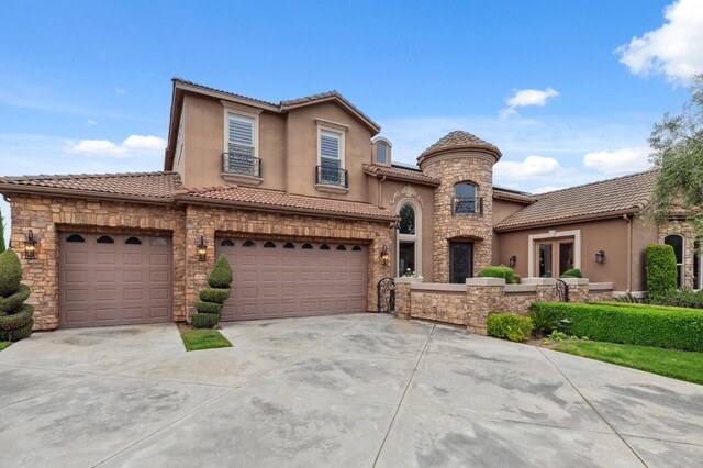 4918 W Bluff Ave, Fresno, CA 93722 - view of front of house with stone siding, a tiled roof, concrete driveway, stucco siding, and french doors