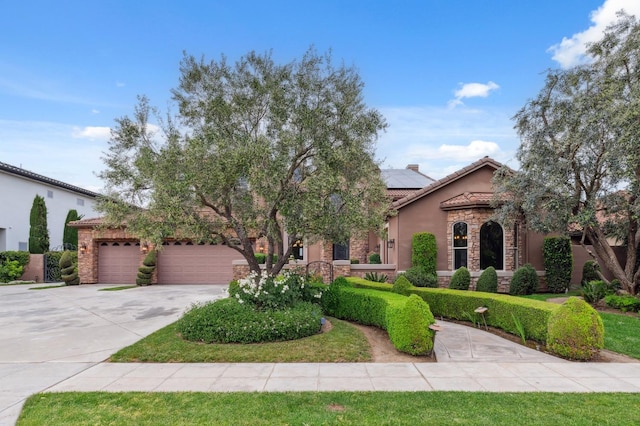 4918 W Bluff Ave, Fresno, CA 93722 - view of front of house featuring concrete driveway, stone siding, a tiled roof, solar panels, and stucco siding
