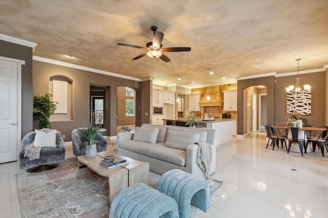 4918 W Bluff Ave, Fresno, CA 93722 - living room featuring light tile patterned floors, arched walkways, ceiling fan with notable chandelier, and ornamental molding