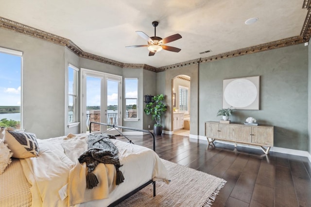 4918 W Bluff Ave, Fresno, CA 93722 - bedroom with visible vents, a water view, dark wood-style floors, arched walkways, and ensuite bath