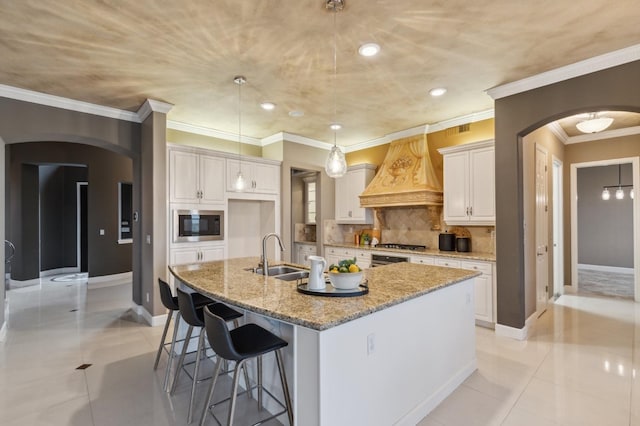 4918 W Bluff Ave, Fresno, CA 93722 - kitchen with custom exhaust hood, built in microwave, arched walkways, and a sink
