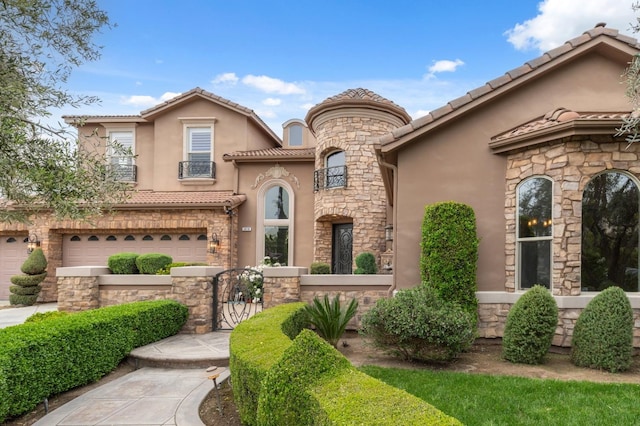 4918 W Bluff Ave, Fresno, CA 93722 - mediterranean / spanish house featuring stone siding, stucco siding, a tiled roof, and a garage