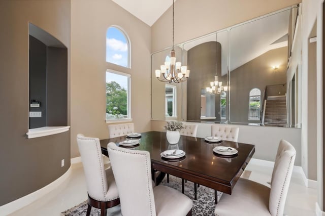4918 W Bluff Ave, Fresno, CA 93722 - dining space with baseboards, high vaulted ceiling, a notable chandelier, and plenty of natural light