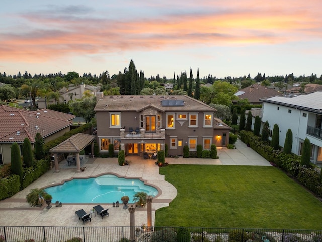 4918 W Bluff Ave, Fresno, CA 93722 - back of house with a gazebo, a patio area, solar panels, a yard, and a fenced backyard