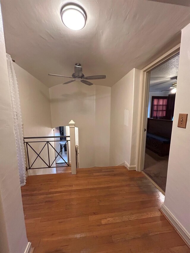 523 W Yosemite, Madera, CA 93637 - hallway featuring baseboards, wood finished floors, and an upstairs landing