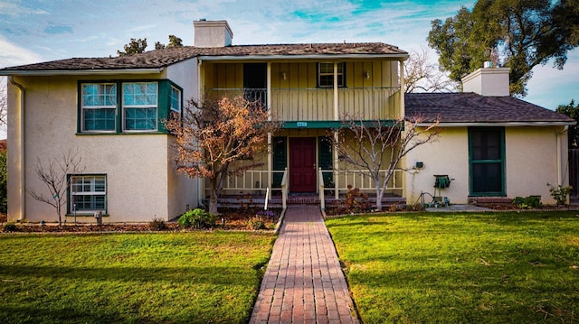 523 W Yosemite, Madera, CA 93637 - traditional home featuring a chimney, stucco siding, a front lawn, and a balcony