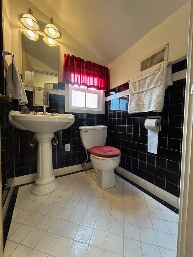 523 W Yosemite, Madera, CA 93637 - bathroom with toilet, tile patterned floors, tile walls, lofted ceiling, and visible vents