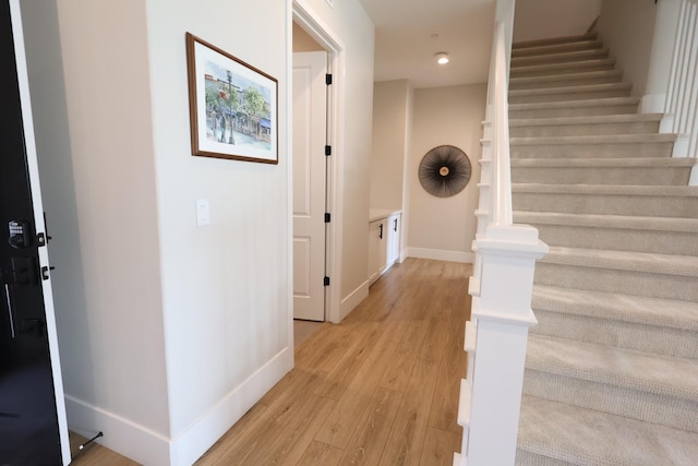 hall featuring stairway, recessed lighting, light wood-style flooring, and baseboards