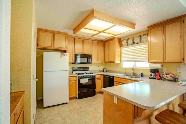 240 S Kenneth Ave, Kerman, CA 93630 - kitchen with black appliances, a sink, a peninsula, light countertops, and a kitchen breakfast bar