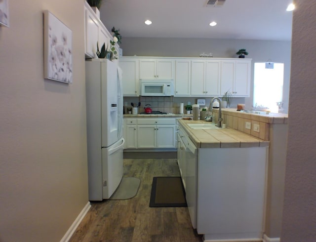 14335 Spyglass Cir, Chowchilla, CA 93610 - kitchen with white appliances, tile counters, a sink, dark wood-style floors, and recessed lighting