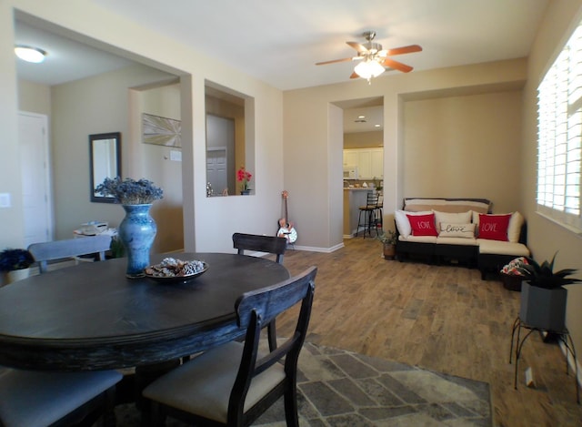 14335 Spyglass Cir, Chowchilla, CA 93610 - dining area featuring wood finished floors, a ceiling fan, and baseboards