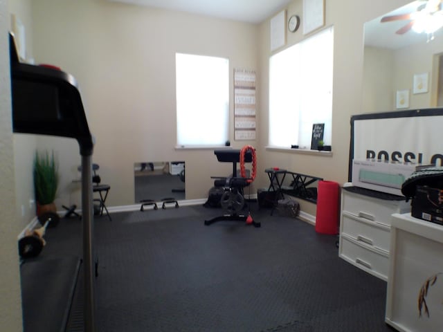 14335 Spyglass Cir, Chowchilla, CA 93610 - workout room featuring a ceiling fan and baseboards