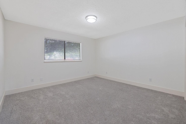 465 W Woods Ave, Tipton, CA 93272 - carpeted empty room featuring baseboards and a textured ceiling