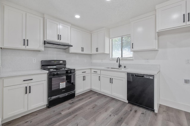 465 W Woods Ave, Tipton, CA 93272 - kitchen with black appliances, white cabinetry, under cabinet range hood, and a sink
