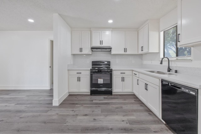 465 W Woods Ave, Tipton, CA 93272 - kitchen featuring white cabinetry, black appliances, under cabinet range hood, and a sink