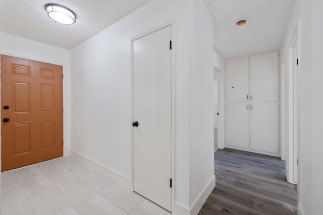 465 W Woods Ave, Tipton, CA 93272 - entryway with baseboards, light wood-style floors, and a textured ceiling