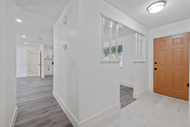 465 W Woods Ave, Tipton, CA 93272 - foyer entrance featuring a textured ceiling, light wood finished floors, and baseboards