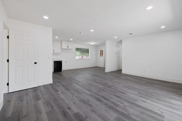 465 W Woods Ave, Tipton, CA 93272 - unfurnished living room with baseboards, recessed lighting, wood finished floors, and a textured ceiling