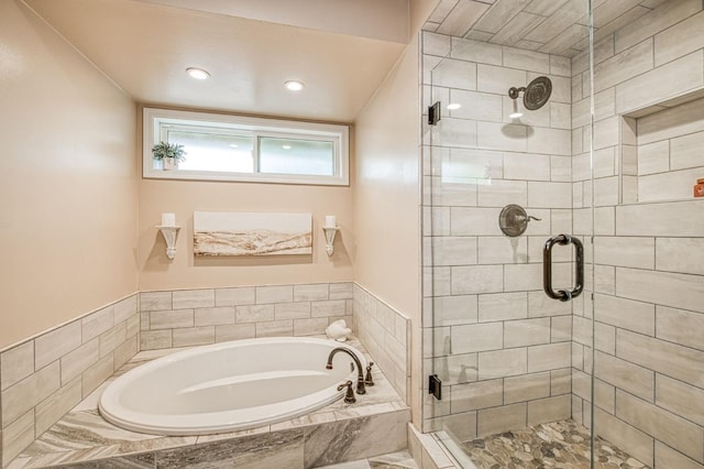 bathroom featuring a shower stall, a garden tub, and recessed lighting