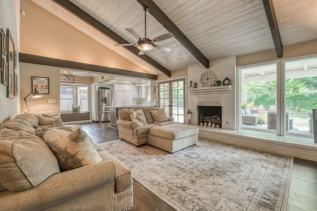 living area featuring plenty of natural light, dark wood finished floors, and beam ceiling