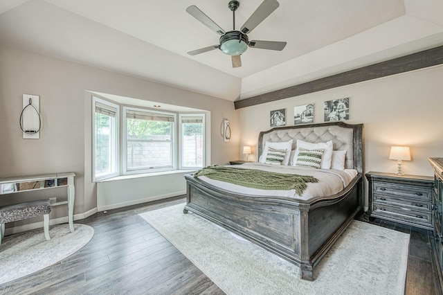 bedroom featuring a ceiling fan, baseboards, and wood finished floors