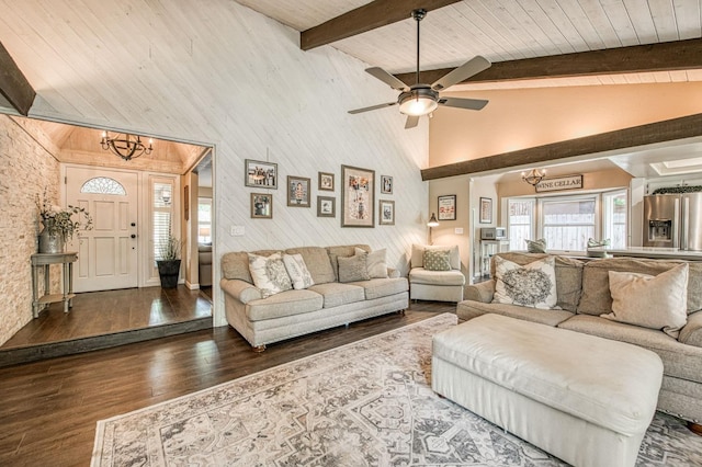 living room with high vaulted ceiling, beam ceiling, ceiling fan with notable chandelier, and wood finished floors
