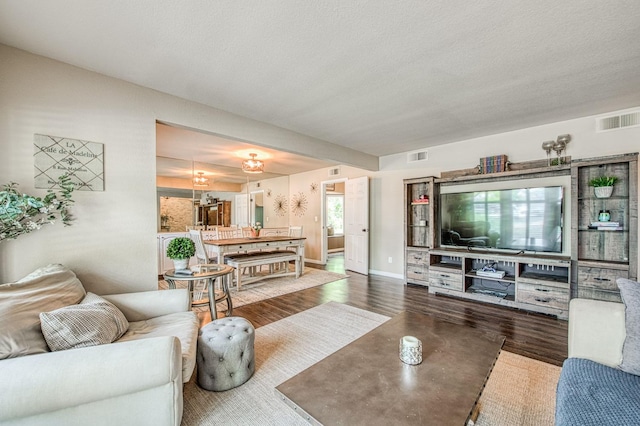 living room with visible vents and baseboards