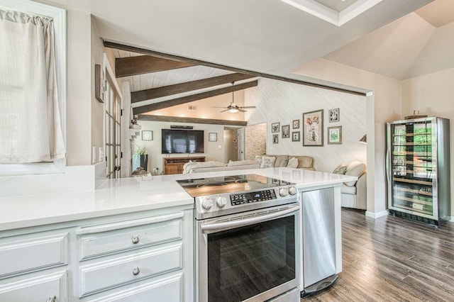 kitchen featuring lofted ceiling with beams, light countertops, beverage cooler, electric stove, and open floor plan