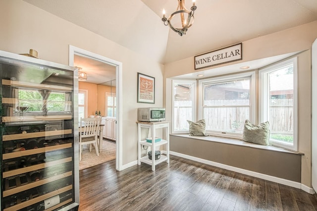 interior space with baseboards, a notable chandelier, and dark wood-type flooring