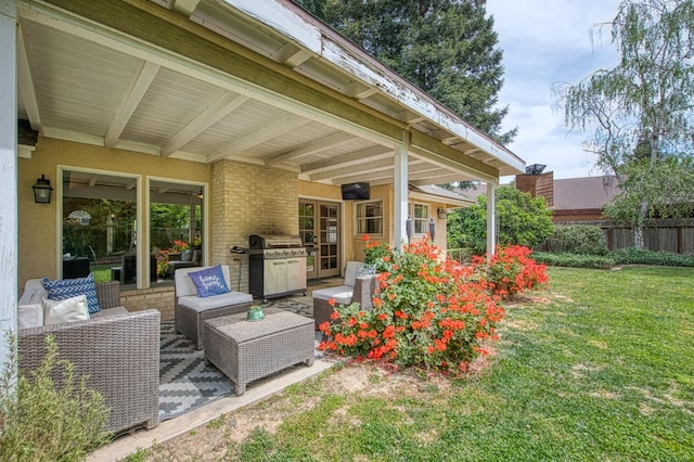 view of patio featuring fence, an outdoor hangout area, and a grill