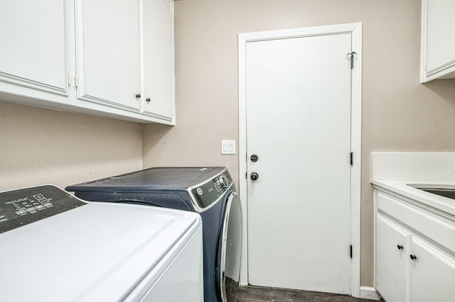 washroom with washing machine and clothes dryer and cabinet space