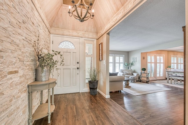 entrance foyer featuring baseboards, dark wood-style floors, high vaulted ceiling, wooden ceiling, and a notable chandelier