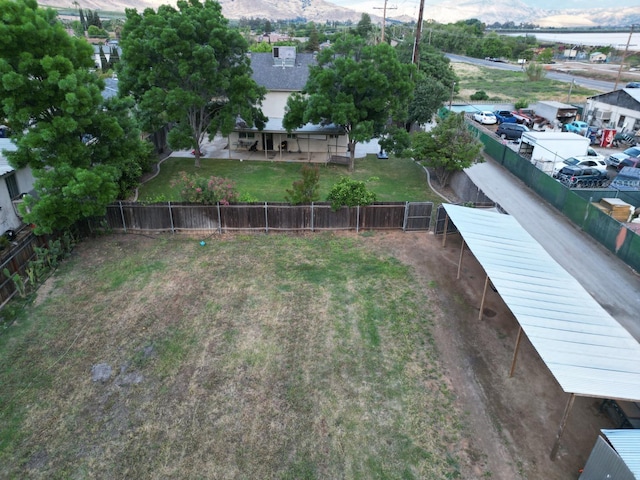 view of yard with fence and a mountain view