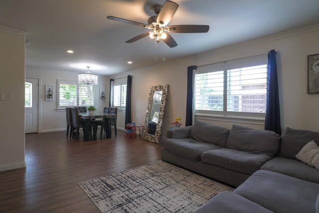 living area featuring wood finished floors, baseboards, ceiling fan with notable chandelier, ornamental molding, and recessed lighting