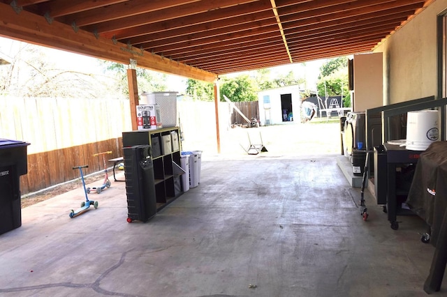 215 W Vine Ave, Visalia, CA 93291 - view of patio featuring an outbuilding, a fenced backyard, and a storage shed