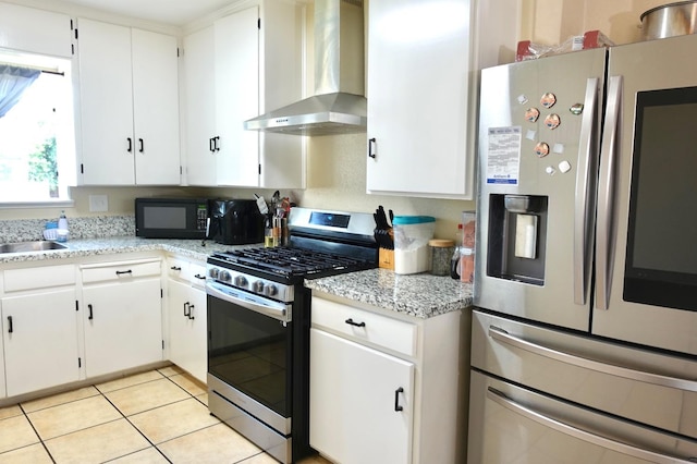 215 W Vine Ave, Visalia, CA 93291 - kitchen featuring white cabinetry, appliances with stainless steel finishes, light tile patterned floors, and wall chimney exhaust hood