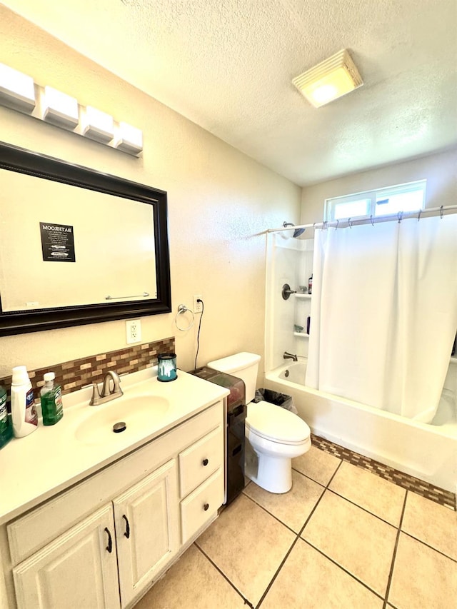 215 W Vine Ave, Visalia, CA 93291 - full bathroom with tile patterned flooring, vanity, toilet, a textured ceiling, and shower / tub combo